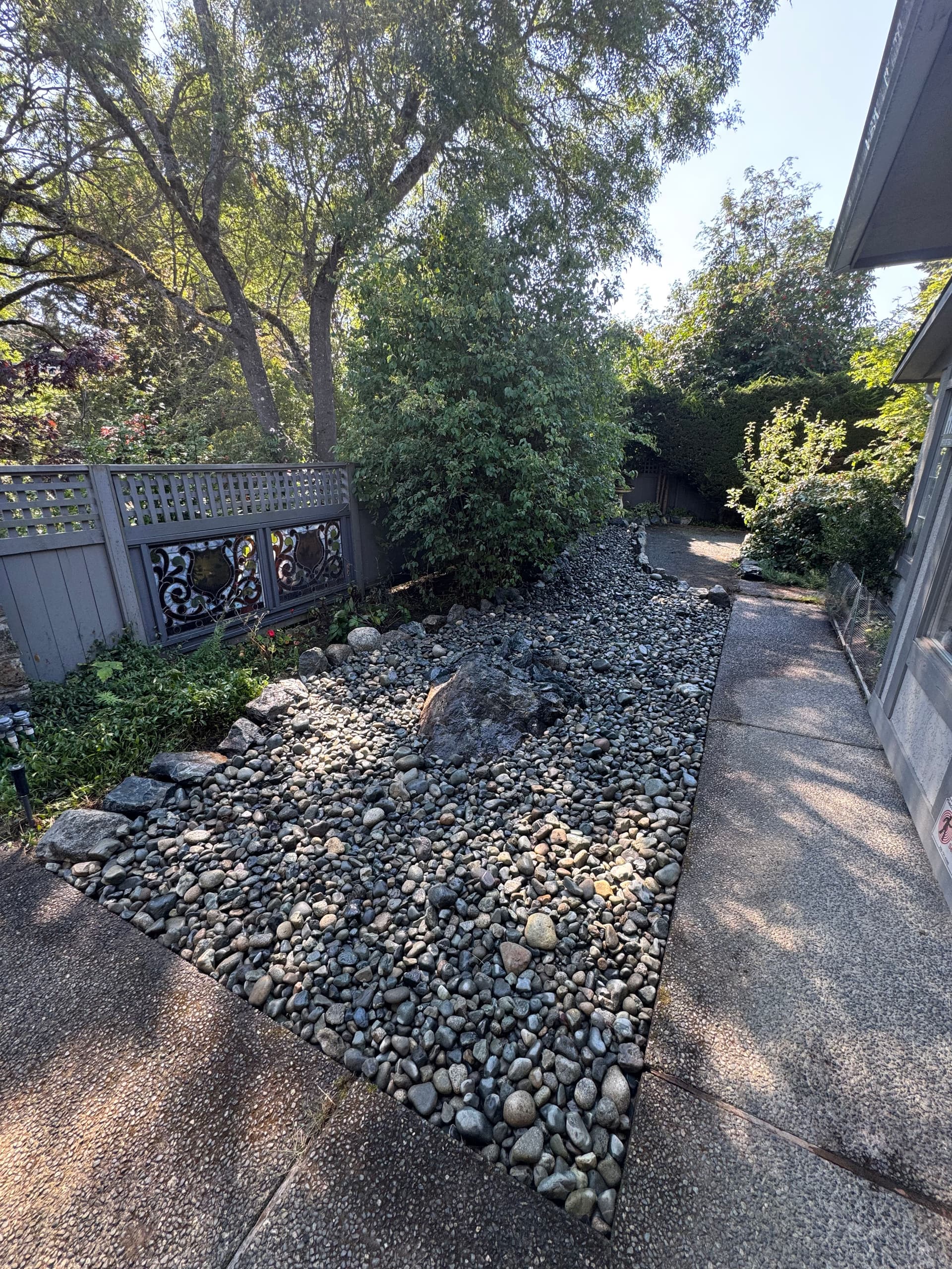 Garden Bed Replaced With a Clean River Rock Feature