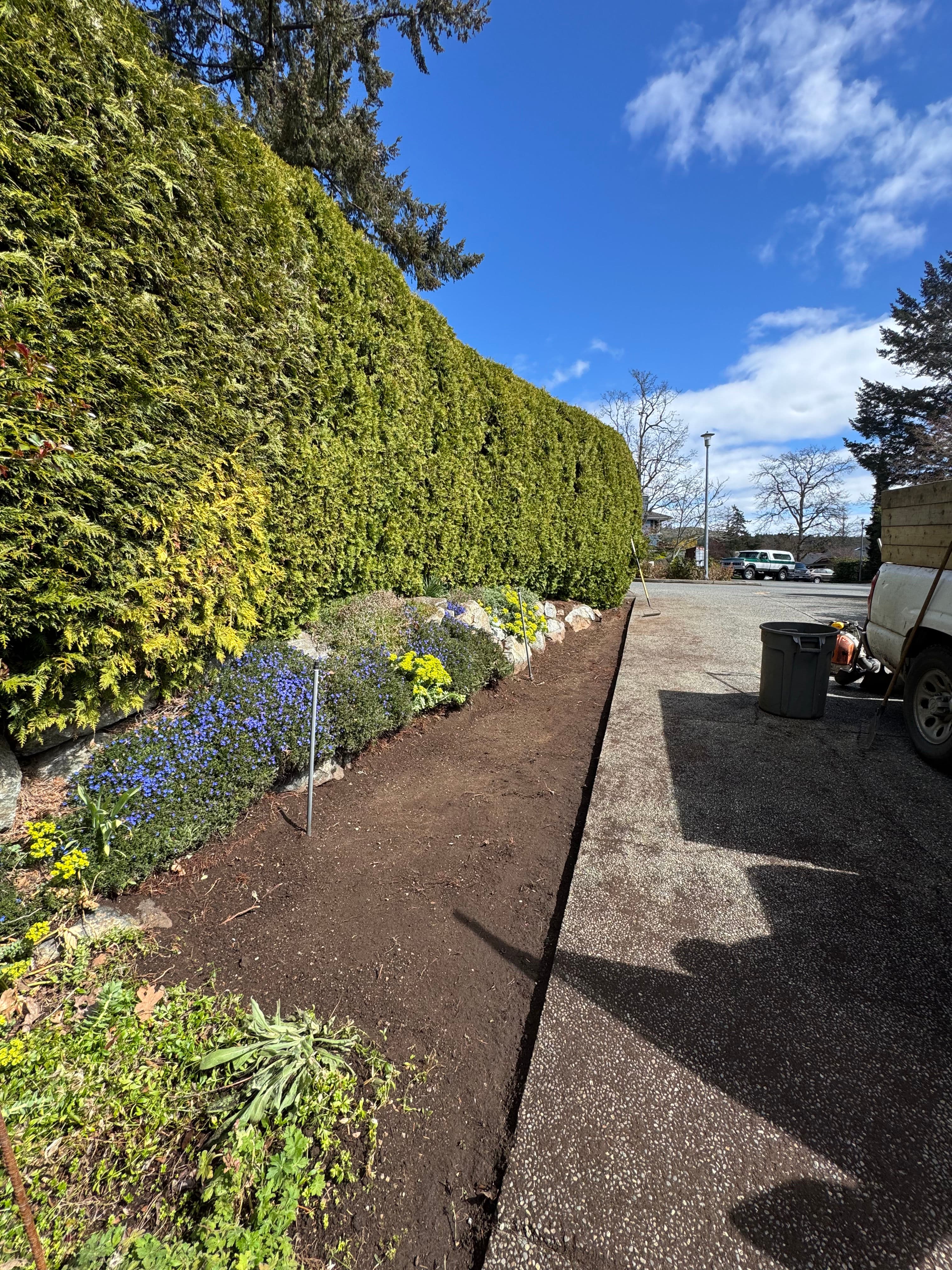 Project Prepping a Garden Bed for River Rock Along a Driveway Path image